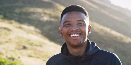 Cropped shot of a young man looking happy while out for a run
