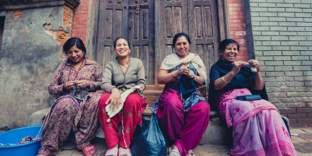 Group of women in Bhaktapur smiling and working in the street