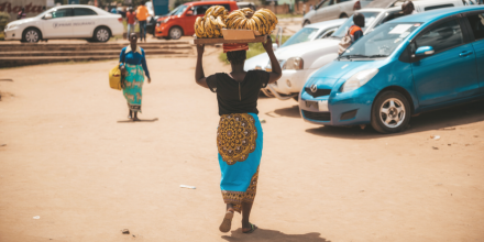 Malawi woman carrying bananas on her head