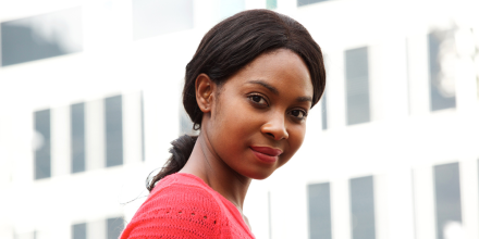 Close up side portrait of young black woman in the city