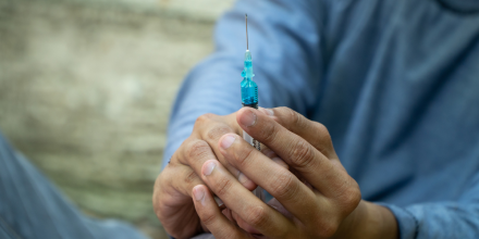 Close up of syringe and needle in hand