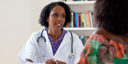 African american female doctor talking to patient at hospital