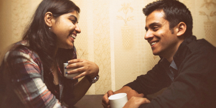 Young Indian couple having coffee together