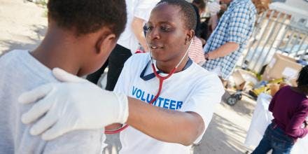 African doctor examining a young patient with a stethoscope