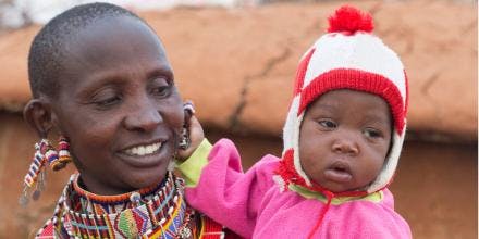 Smiling Maasai mother with young daughter