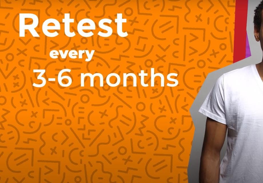A still from a video about reasons to retest for HIV, a young man smiles while text reads "retest every three to six months"