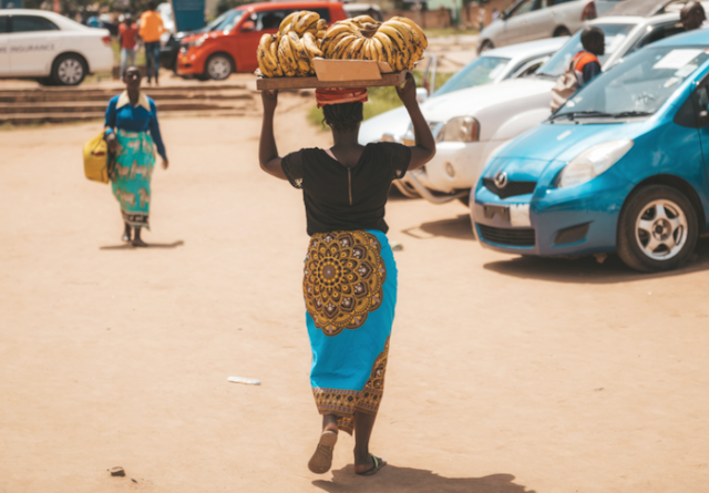 Malawi woman carrying bananas on her head