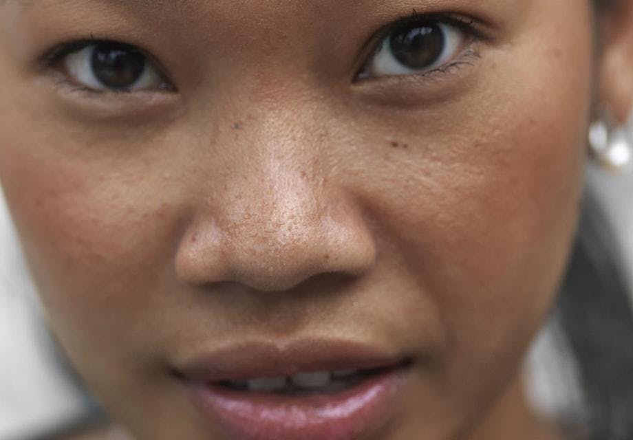 Close up of a young Cambodian woman looking at the camera