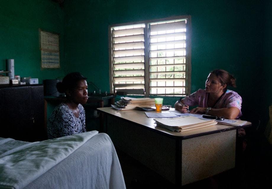 A doctor talks to a female patient in rural clinic in Honduras