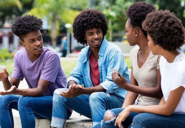A group of young people chatting in an urban park