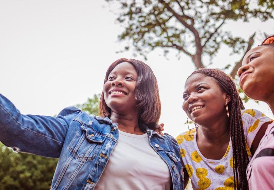 A group of three young Zambian women taking a selfie