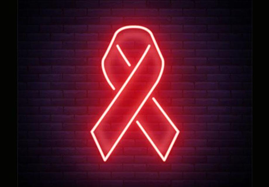 A red neon sign shaped as an HIV ribbon