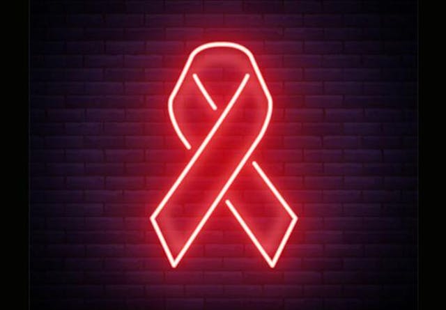 A red neon sign shaped as an HIV ribbon