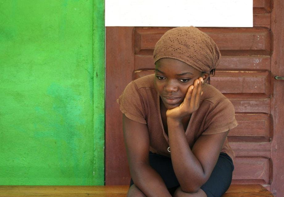 A young woman waiting to be seen at a clinic in Africa