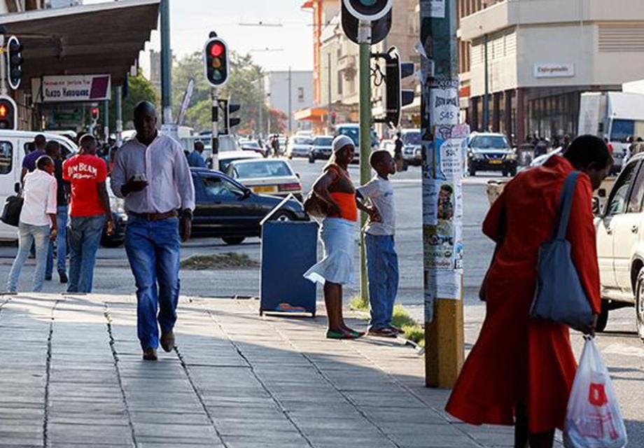 People walking down a street in Bulawayo