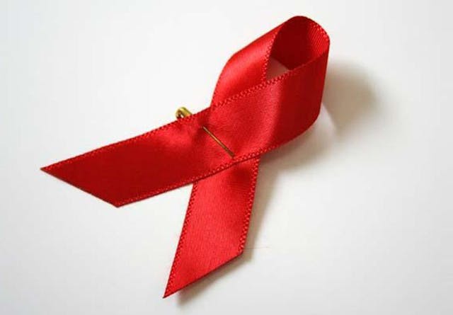A red HIV ribbon on a white background
