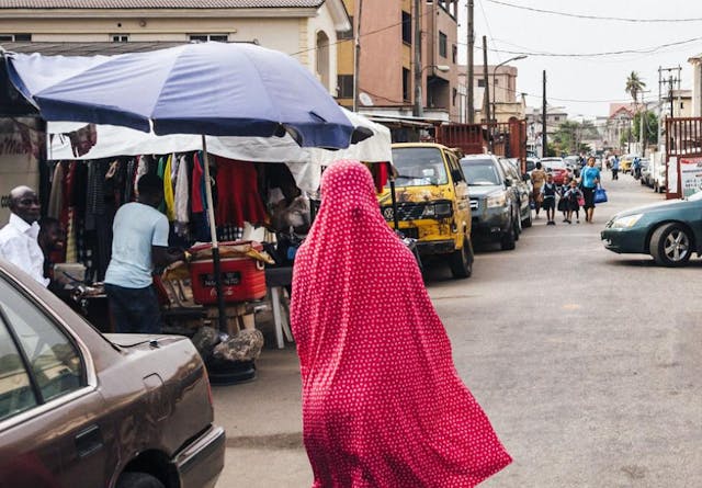 A woman walking down a street in Lagos