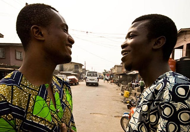 Two men from Lagos talk on the street