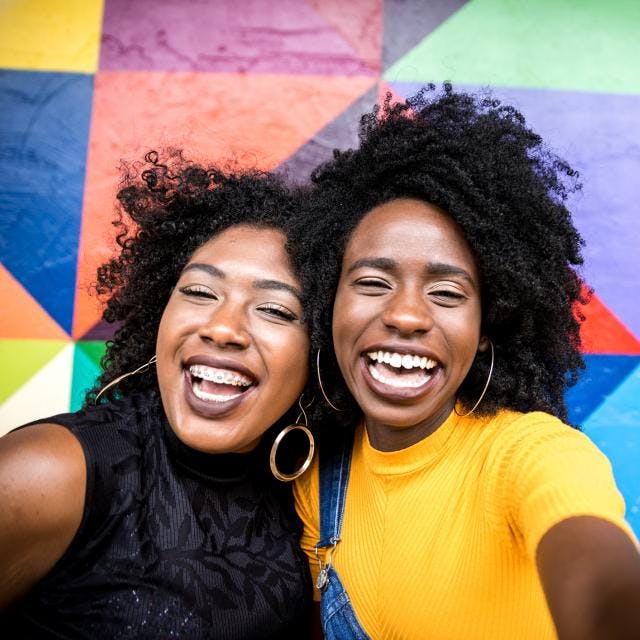 Two young women smiling to the camera